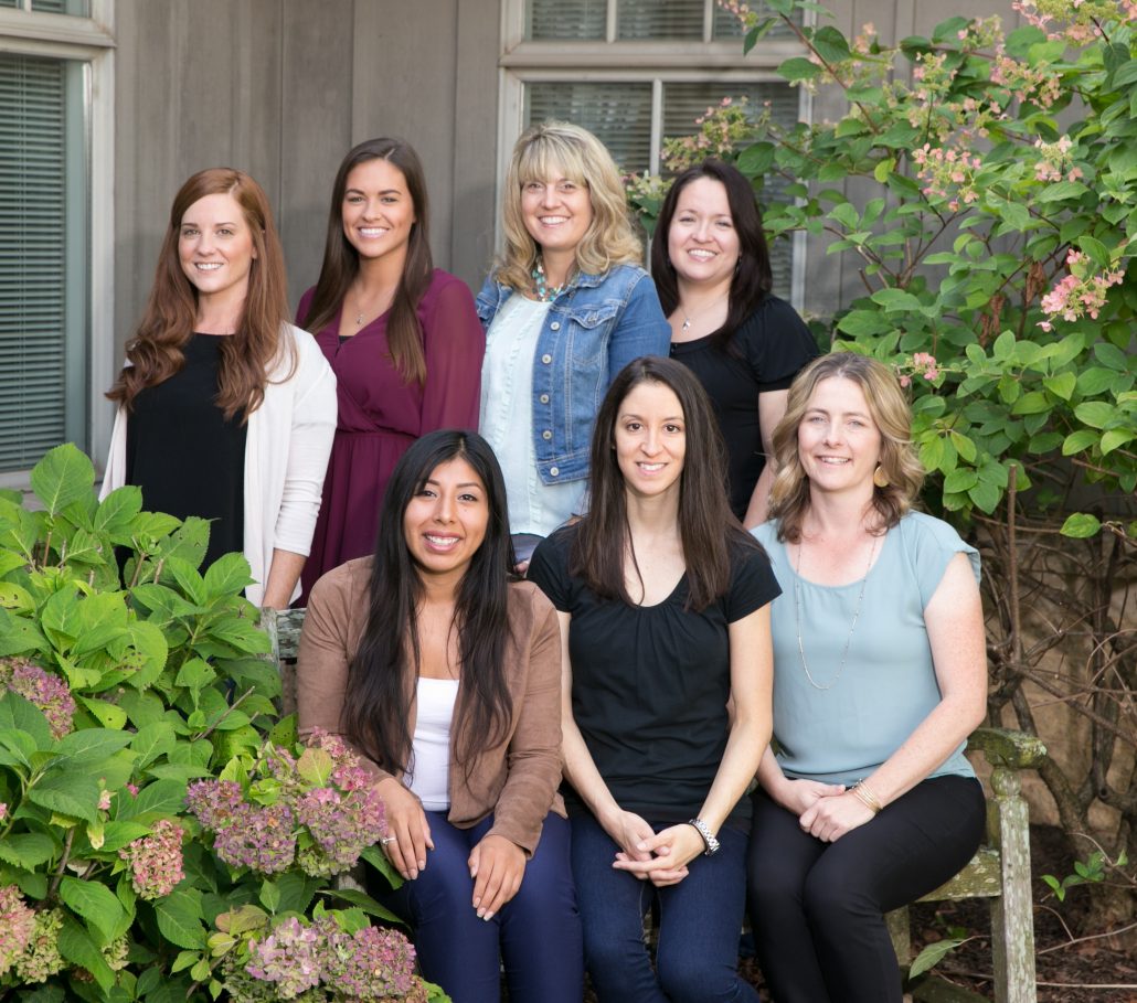 Women sitting and standing in from of camera